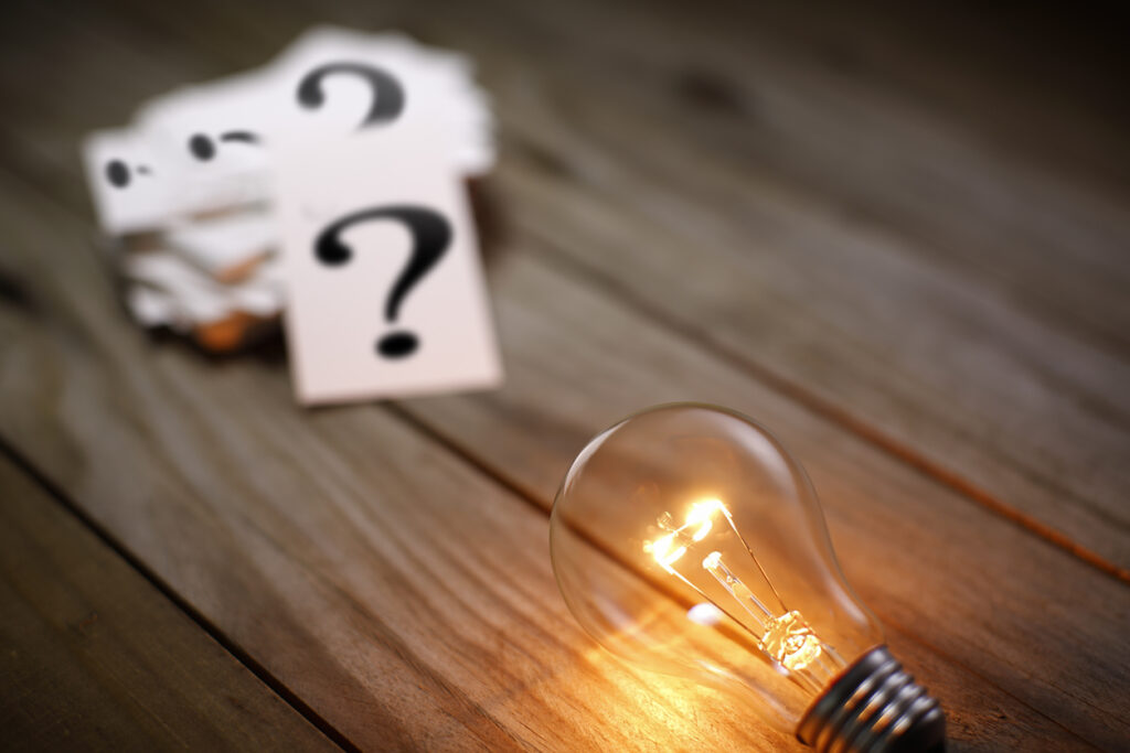 question-mark-and-light-bulb-on-table-patio-lights-concept
